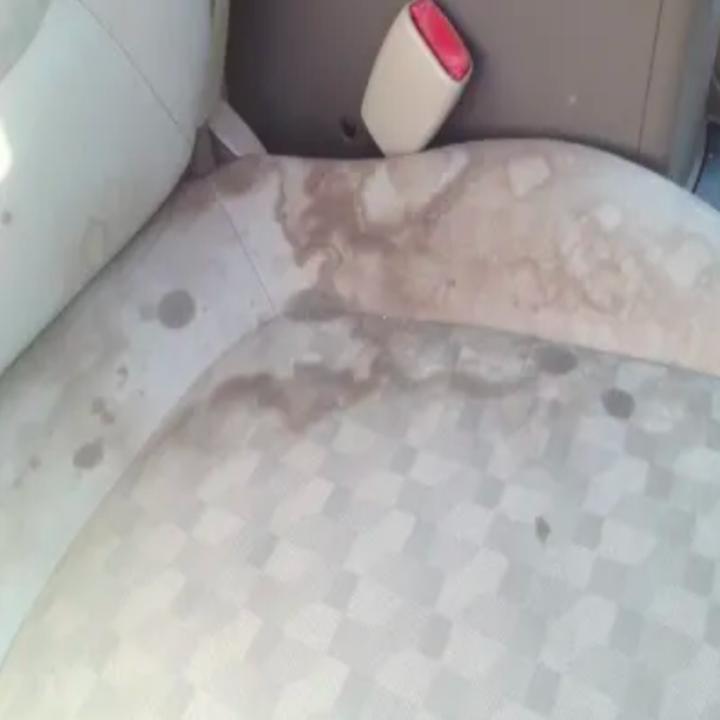 Fabric car seat covered in stains 
