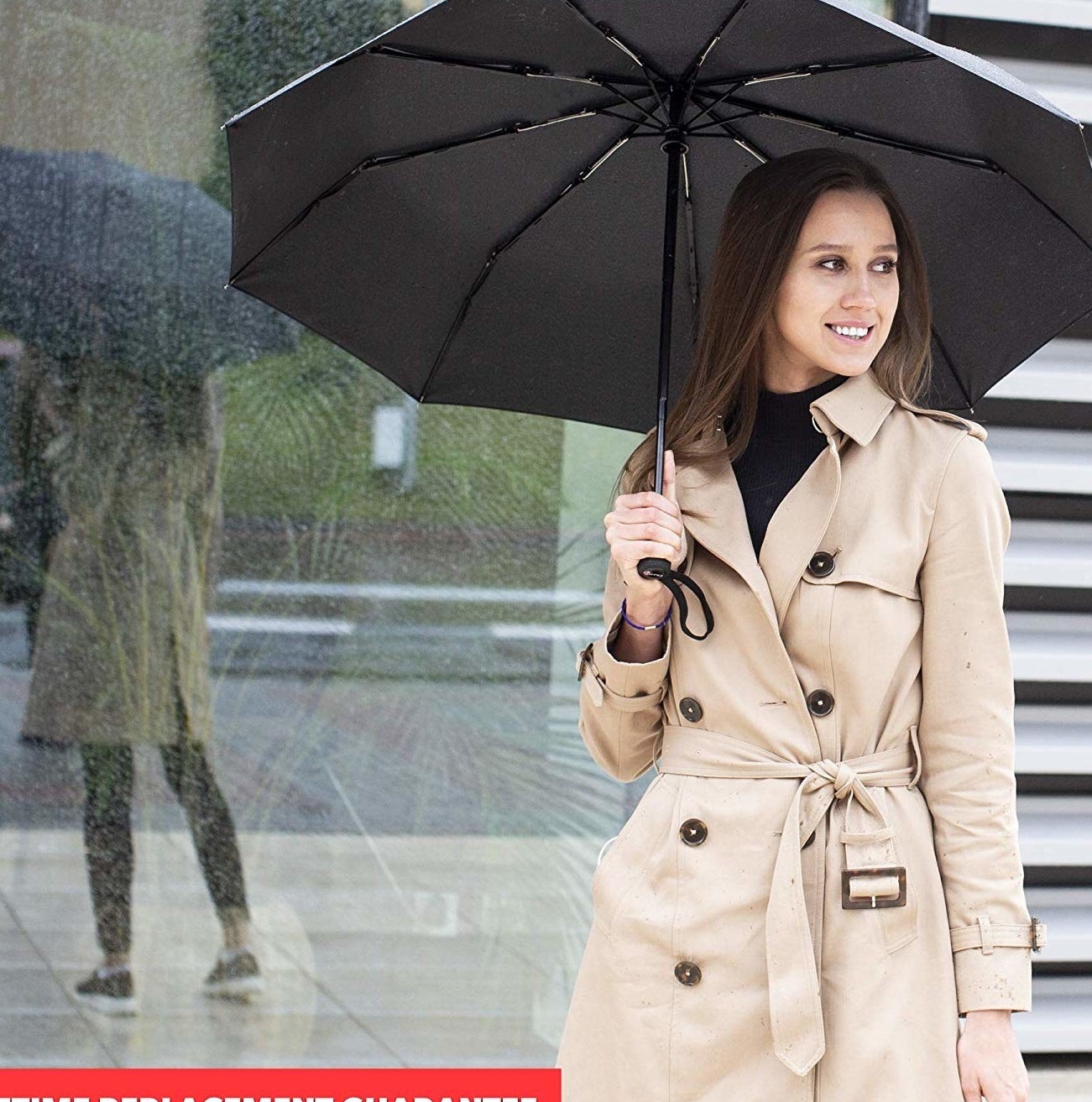 model holding black umbrella