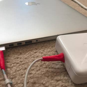 red sugru strengthening mac charger cables where the wires meet the magsafe plug and the brick part