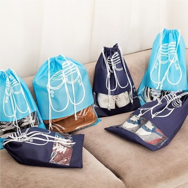 drawstring bags in light blue and dark blue with a clear slot near the bottom, showing that there are shows on the inside and illustrations of shoes on the outside