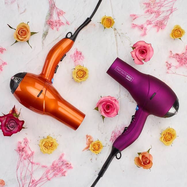 one berry-colored and one orange conair hair dryer