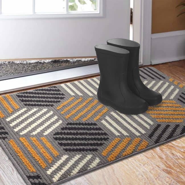 gray, yellow, and black abstract mat at door