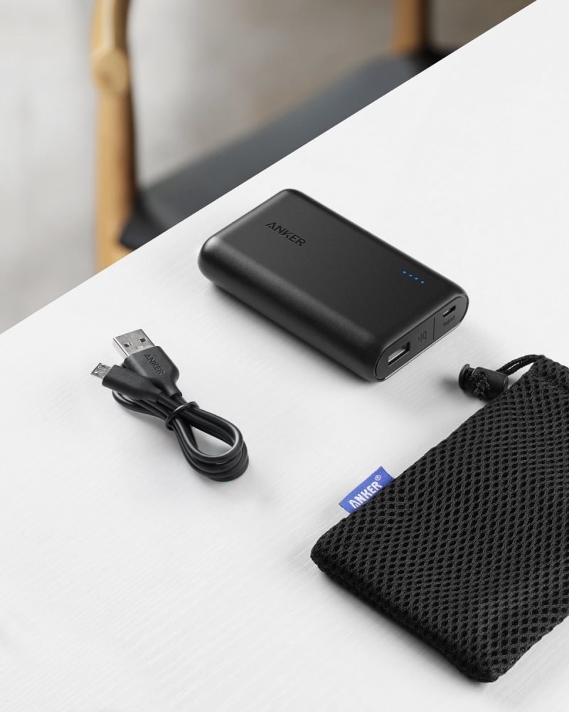 the rectangle power bank in black with cord and mesh pouch sitting next to it
