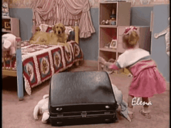 gif of Michelle Tanner in the TV show &quot;Full House&quot; tapping an overstuffed suitcase and having a golden retriever jump on it to get it to close