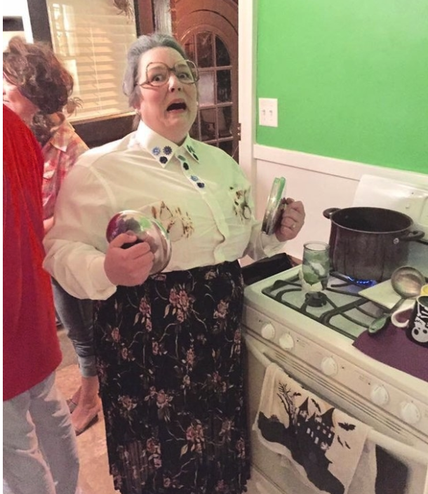 Someone dressed as Mrs. Doubtfire with singe marks over their breasts