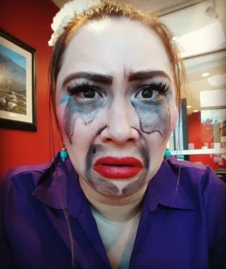 Someone dressed as the Matchmaker with their makeup running down their face