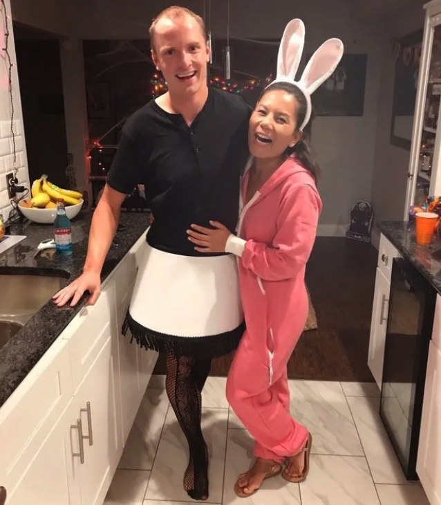A couple in the kitchen dressed as a leg lamp and in bunny pajamas
