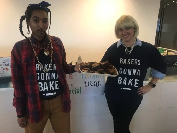 Two people dressed as Snoop Dogg and Martha Stewart, holding brownies