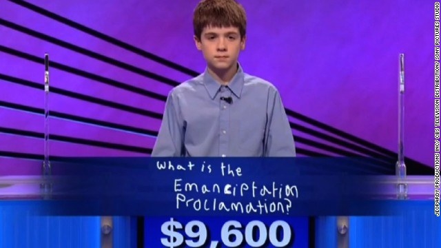 Young boy showing the spelling &quot;What is the Emanciptation Proclamation&quot; and the amount of $9,600