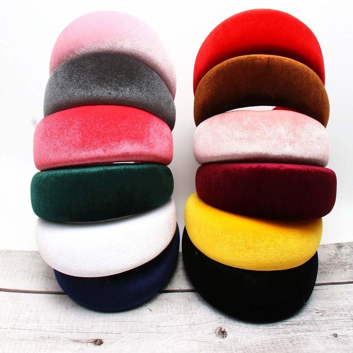 Two stacks of headbands to show the colors, including pink, red, burgundy, yellow, white, green, grey, and brown