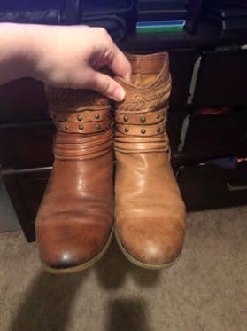 reviewer's ankle boots with one looking worn, then the other looking moisturized and like new with the leather conditioner