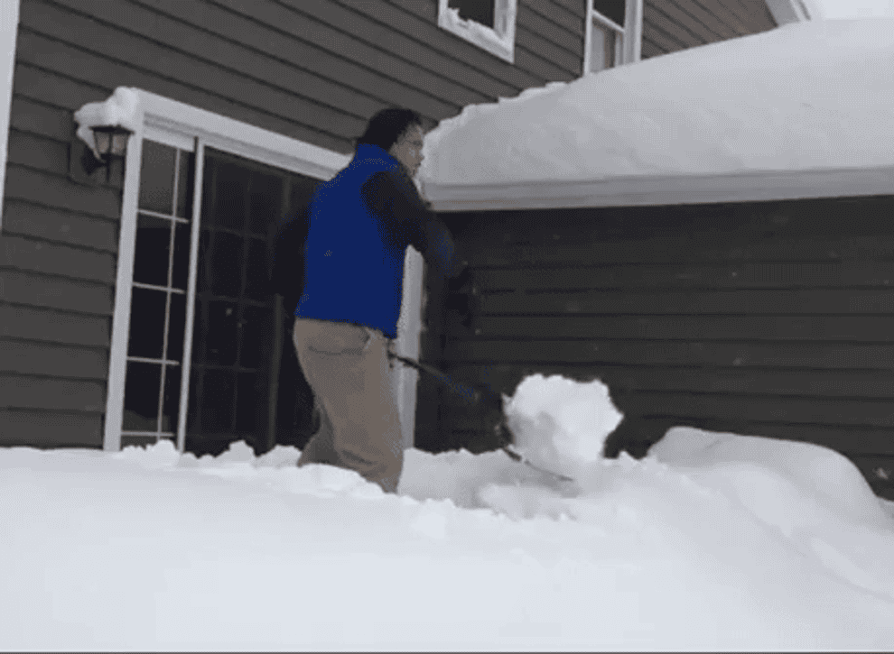 GIF of someone scooping the snow and flinging it off the porch