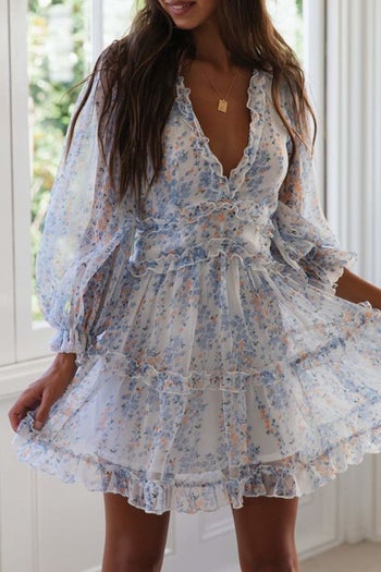 Model wearing the white and blue printed dress
