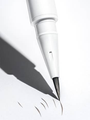 The Brow Flick Pen making markings on a white background 