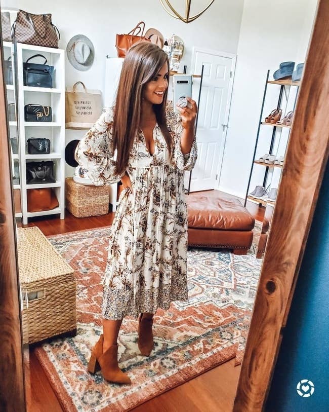 reviewer wearing the dress in white and brown floral