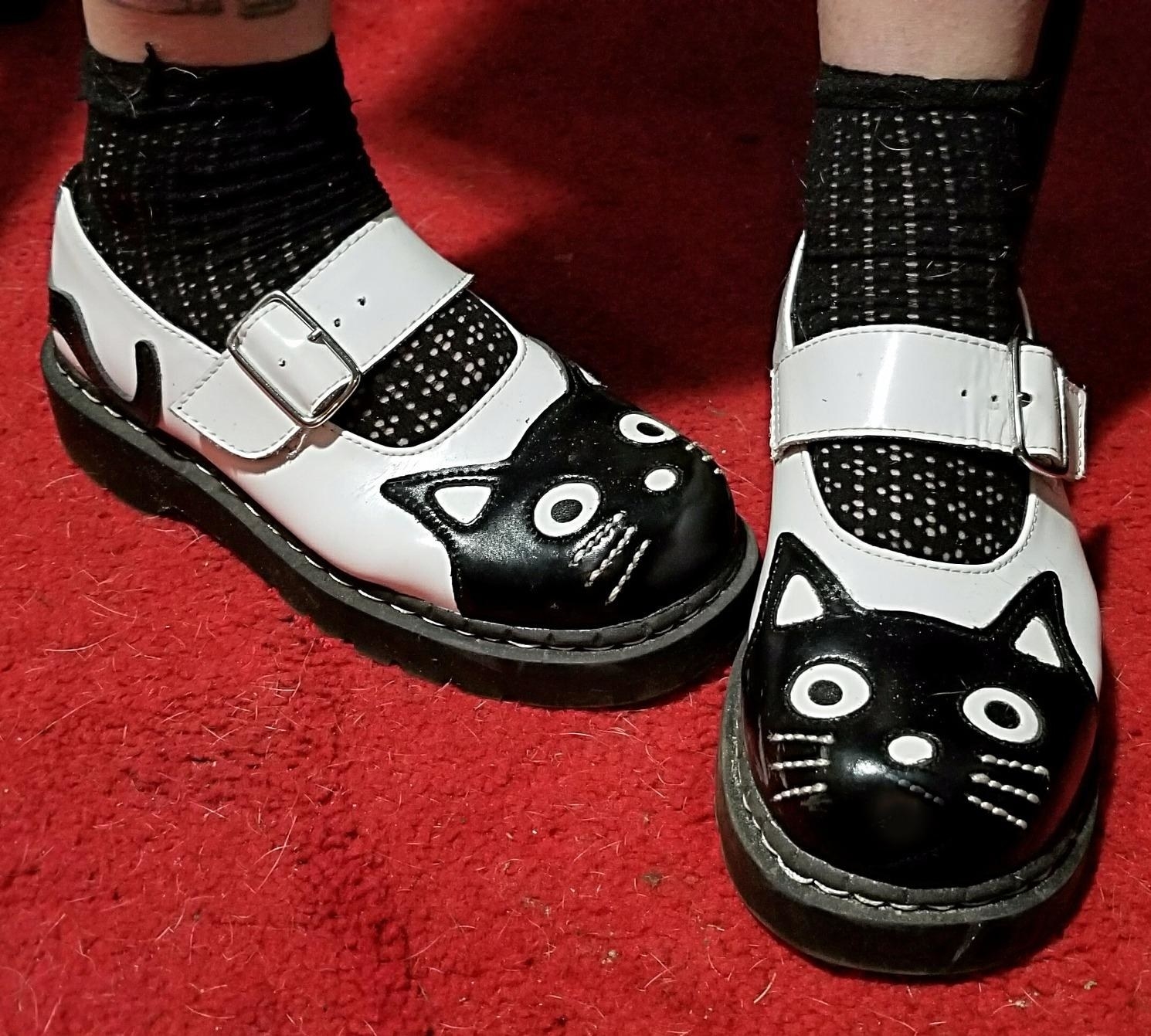 reviewer wearing the black and white cat mary janes