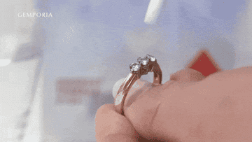Model applying jewelry cleaning stick to ring