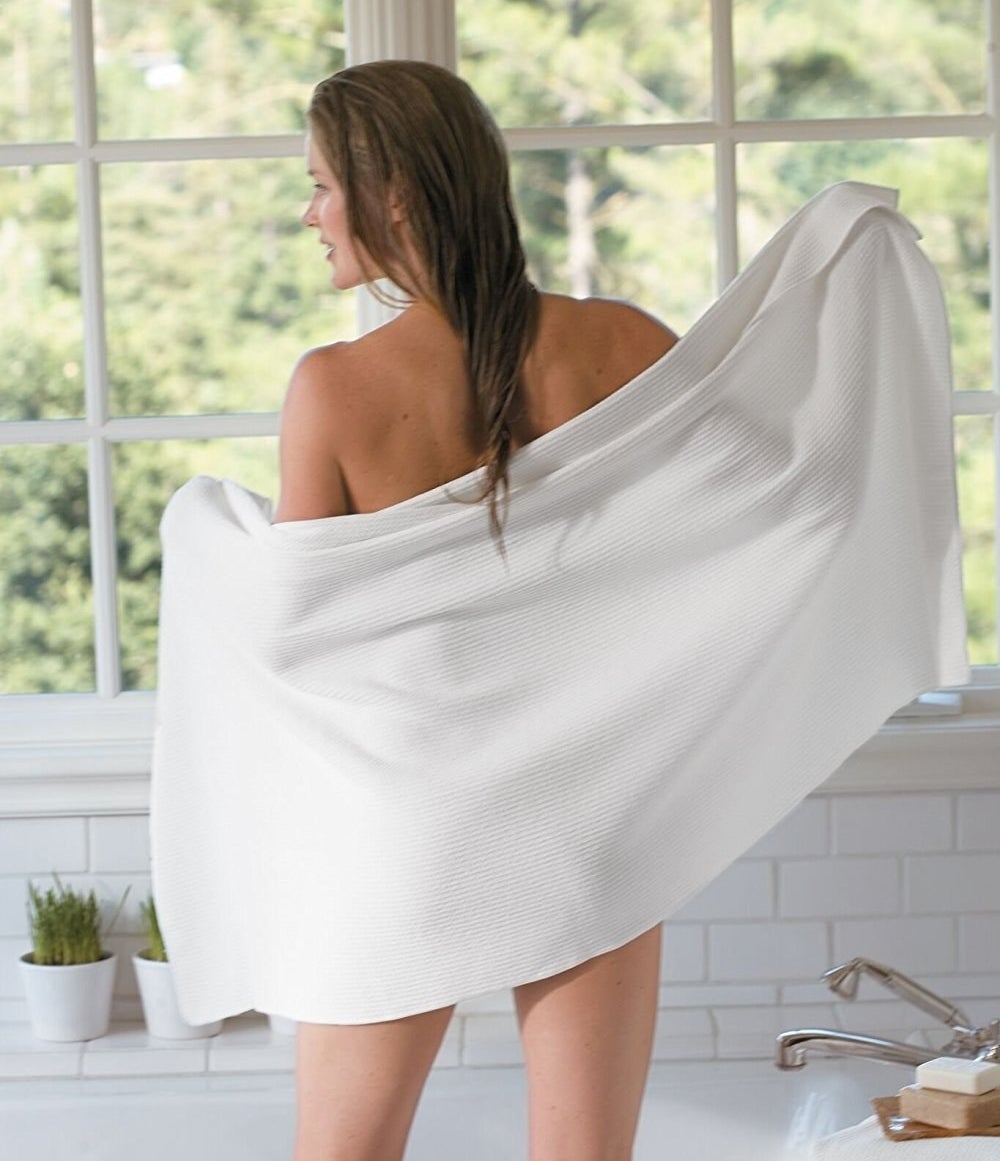 Model using white microfiber body towel. 