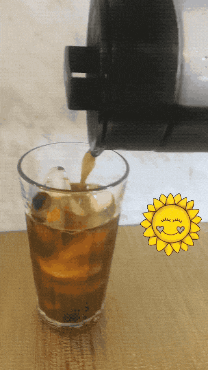 a gif of a buzzfeed editor pouring cold brew into a glass