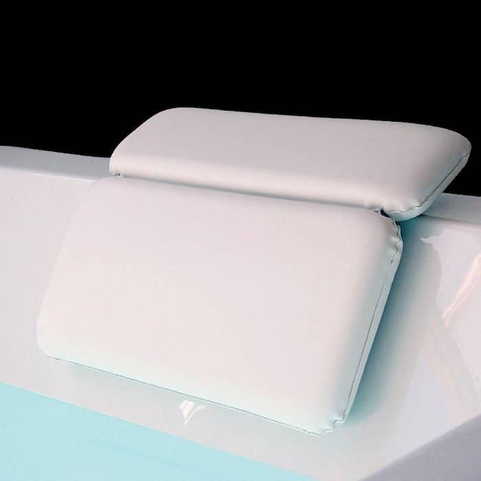 A two-fold pillow attached to the rim of the bath tub