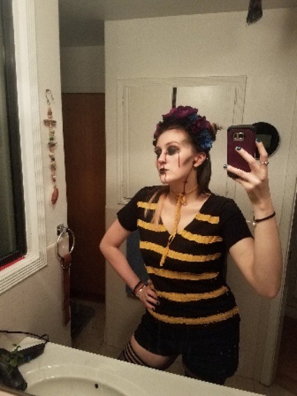 A woman dressed as a bee with spooky, undead zombie makeup