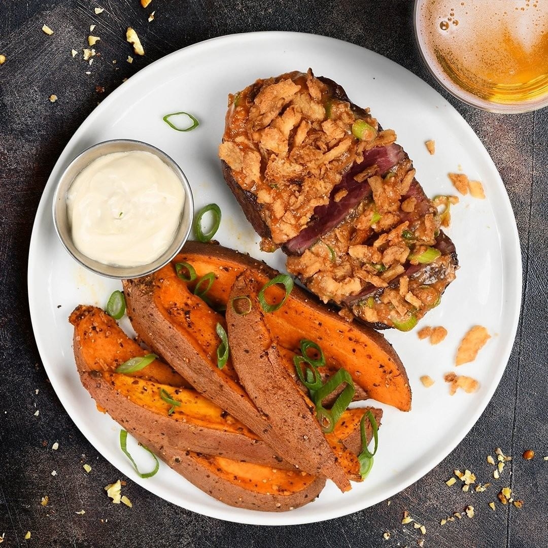 A picture of their sweet potato fries and steak with onions 