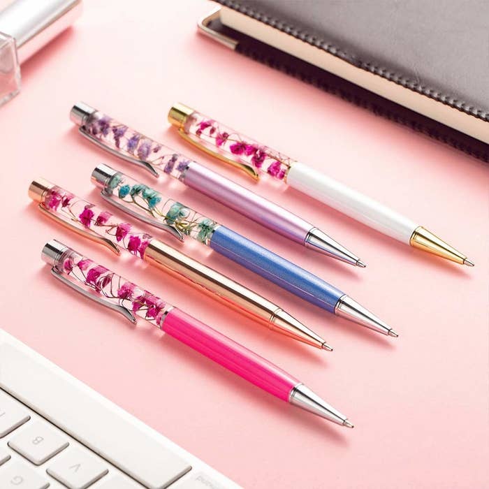 pens with liquid chambers with floating flowers 