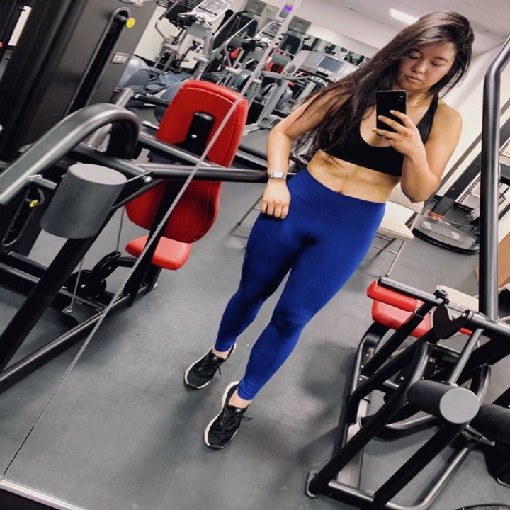 reviewer wearing the leggings in a gym