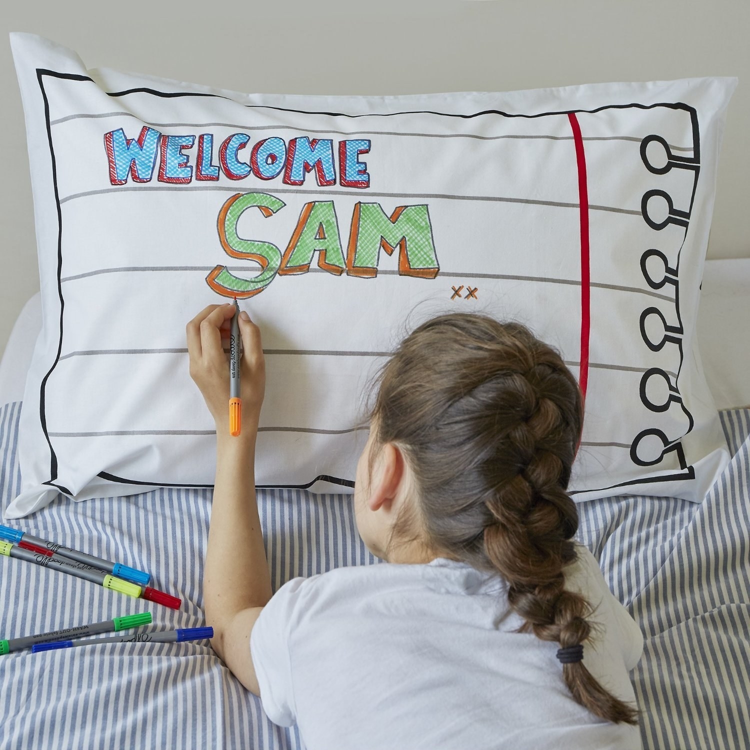 Child drawing on pillowcase that looks like piece of torn notebook paper