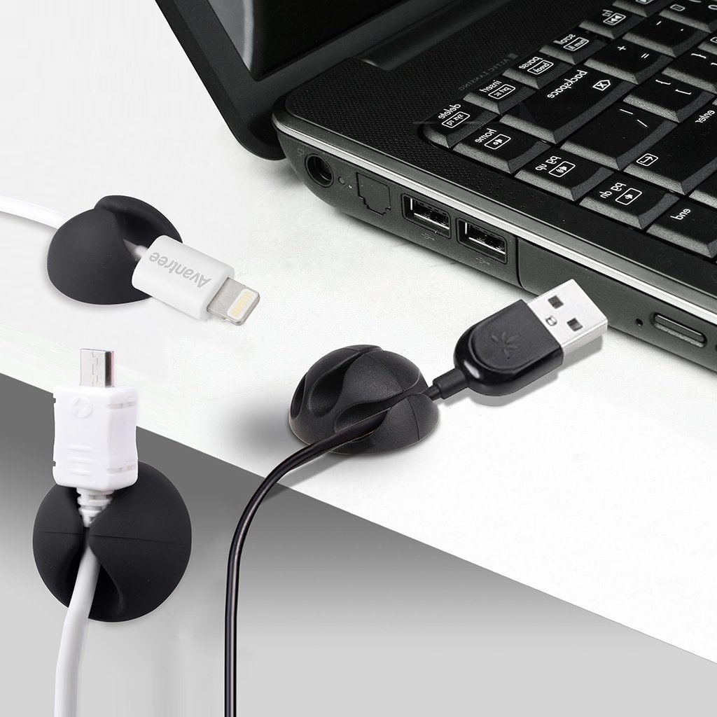 A set of charging cords secured to clips near a laptop