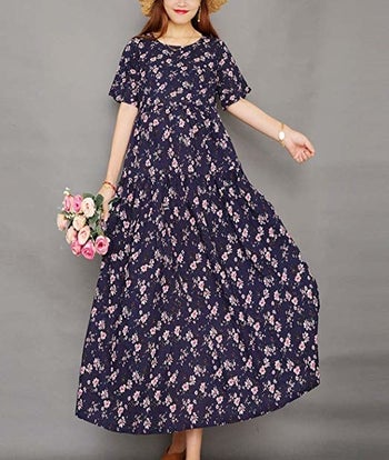 a model in the dress in blue with a white pattern on it