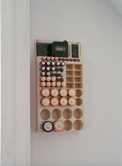 A reviewer's photo of the battery organizer full and mounted to the wall