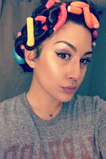 reviewer wearing colorful flexible foam curling rods