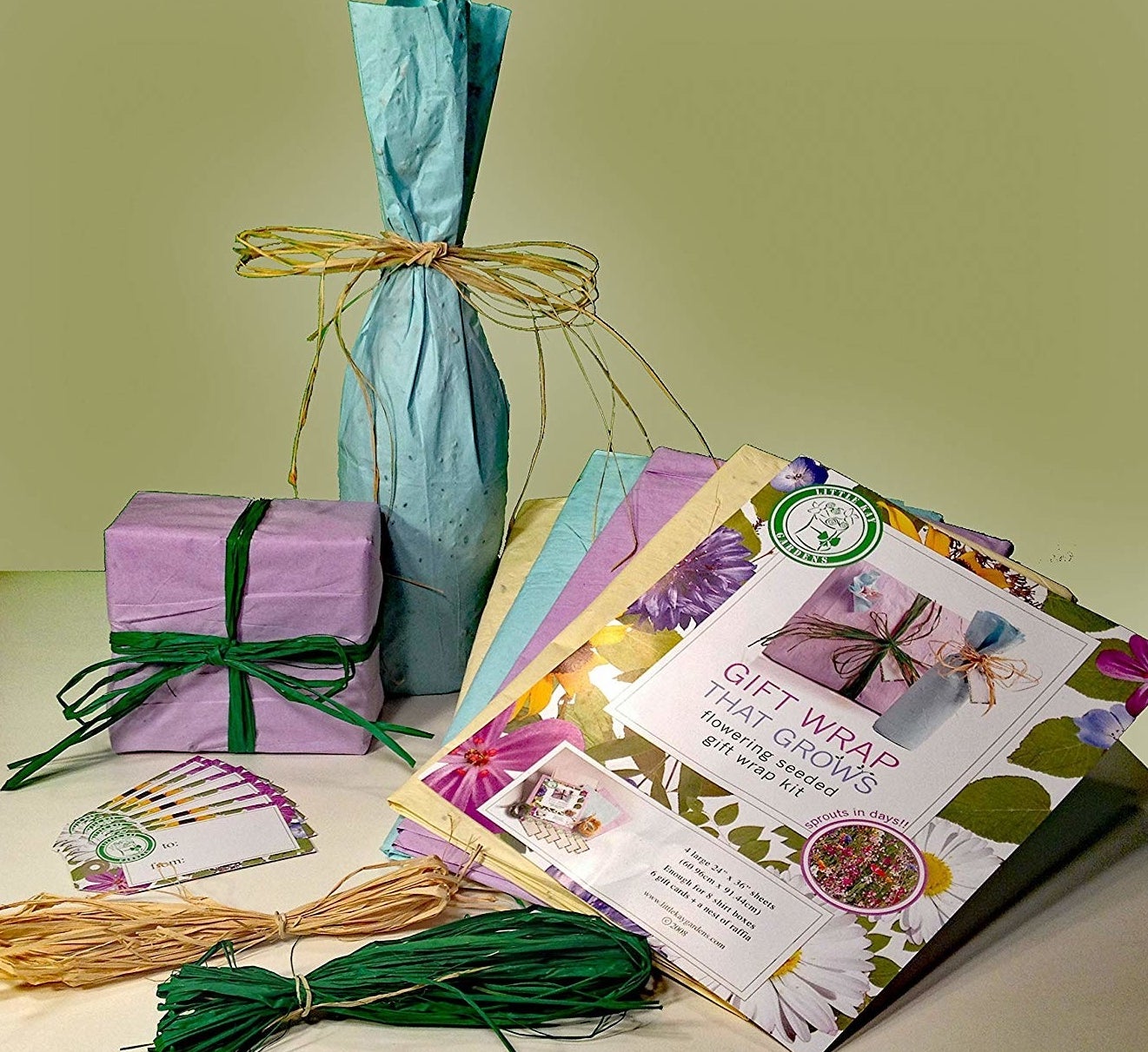 The gift wrap set with sheets in purple, yellow, and green as well as raffia in yellow and green