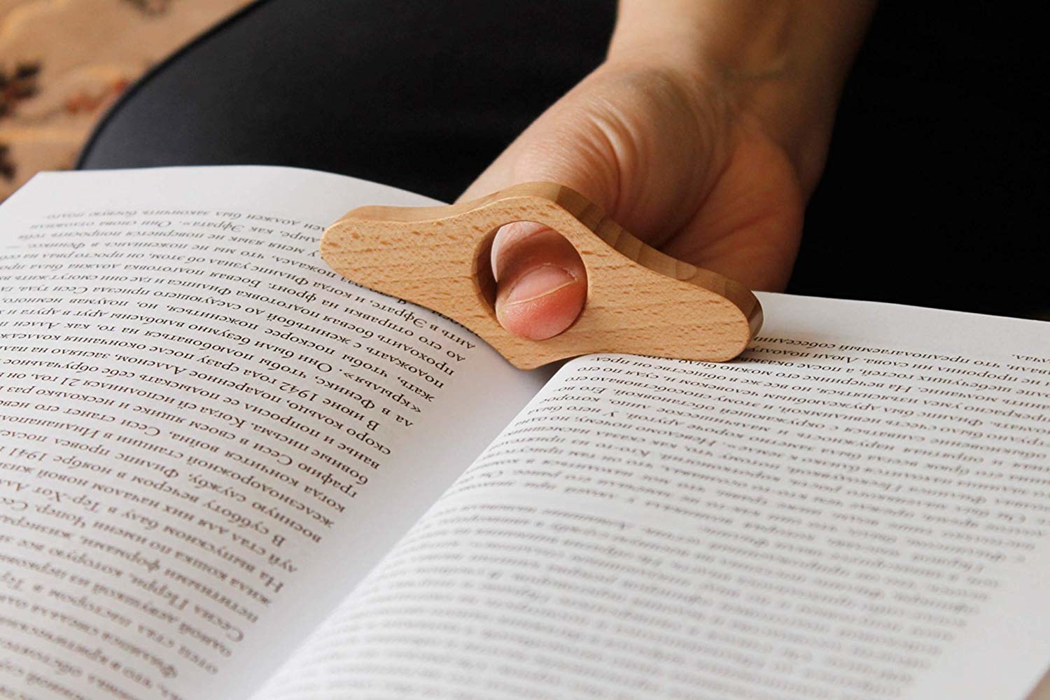 A model using the page holder to hold open a book