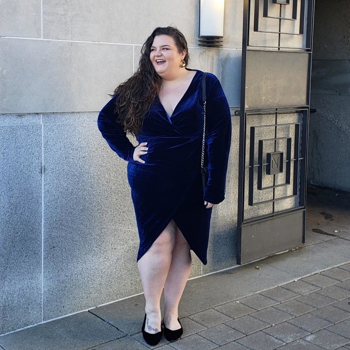 a reviewer wearing the dress in navy