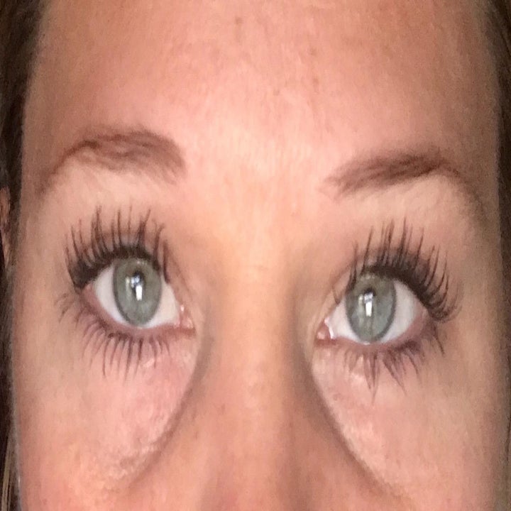 Reviewer with darkened, dramatically lengthened lashes
