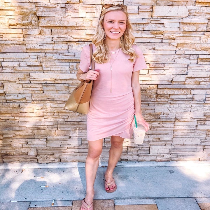 a reviewer wearing the short-sleeve dress in light pink