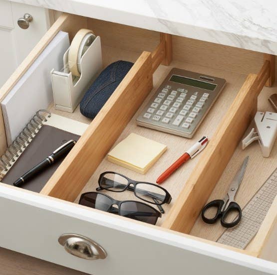 the bamboo divider separating various items in a drawer