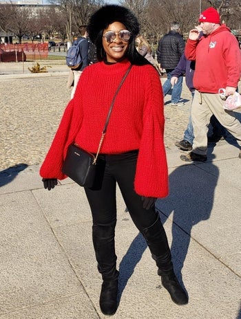 Reviewer wearing the sweater in bright red