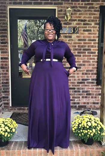 A different reviewer wearing the dress in purple with a belt