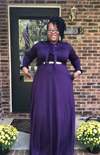 A different reviewer wearing the dress in purple with a belt