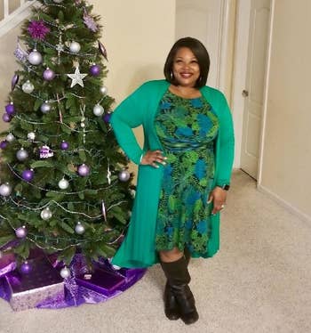 a reviewer wearing the long sweater in light green