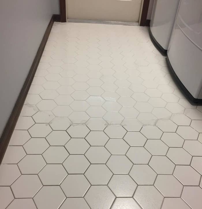 A reviewer photo of a tile floor with half of it dirty between the tiles and the other half very clean between the tiles