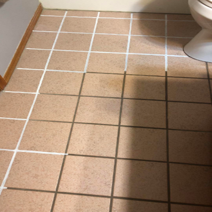 problems solved in 2022 A reviewer's tile partially treated with the product. The original grout is brown and the pen has made it white