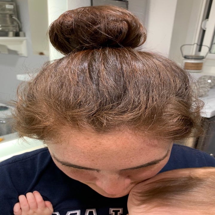 A person showing their messy bun with flyaways