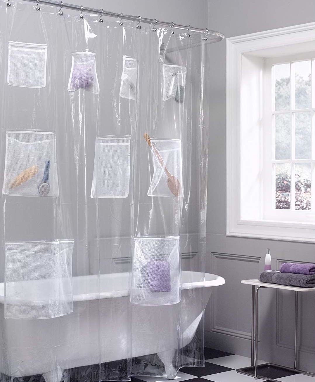 A pocketed shower curtain filled with washcloths, loofahs, and bath products