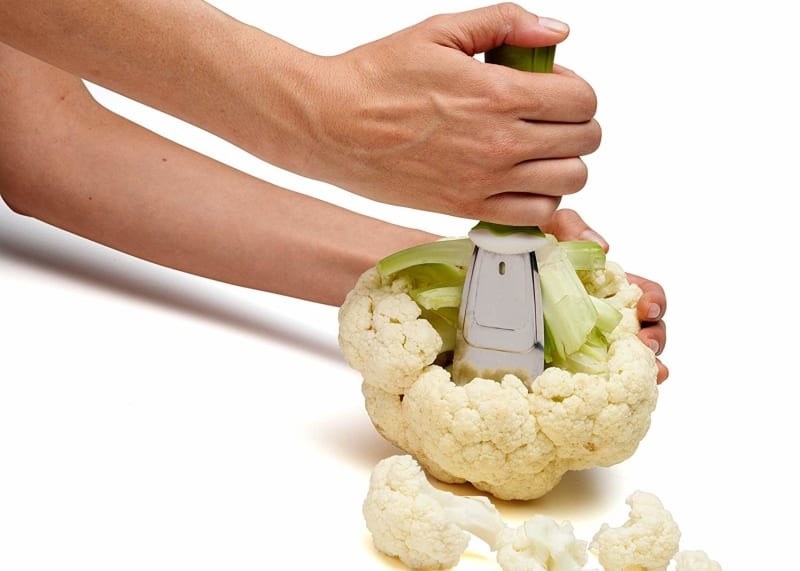 A person de-stalking the cauliflower using the prep tool