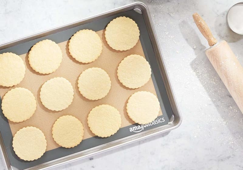 Cookies on top of the baking mat on a cookie sheet