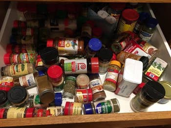 Reviewer pic of bottles of spices messily scattered in a drawer